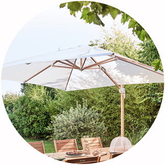 Parasol déporté écru protégeant une table de jardin en bois sur terrasse